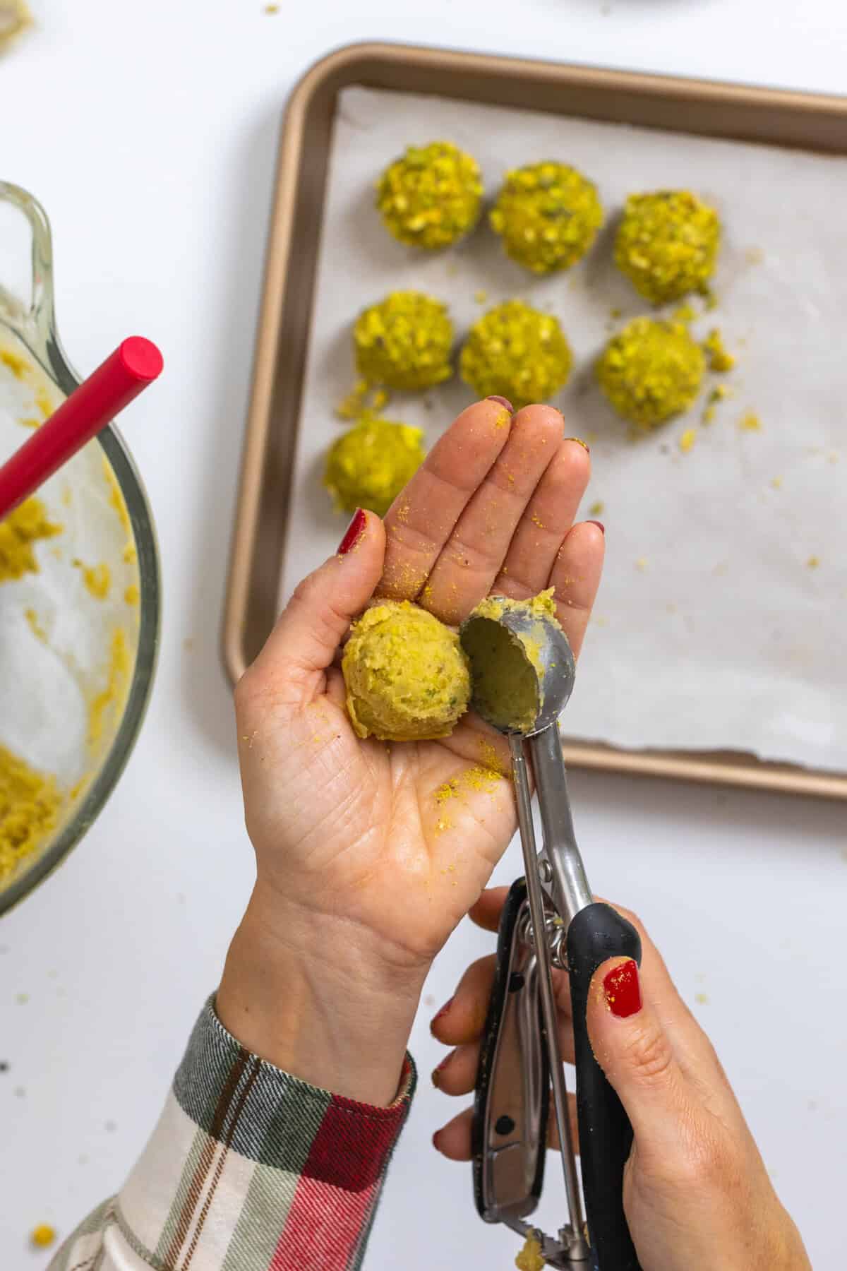 scooping pistachio cookie dough balls
