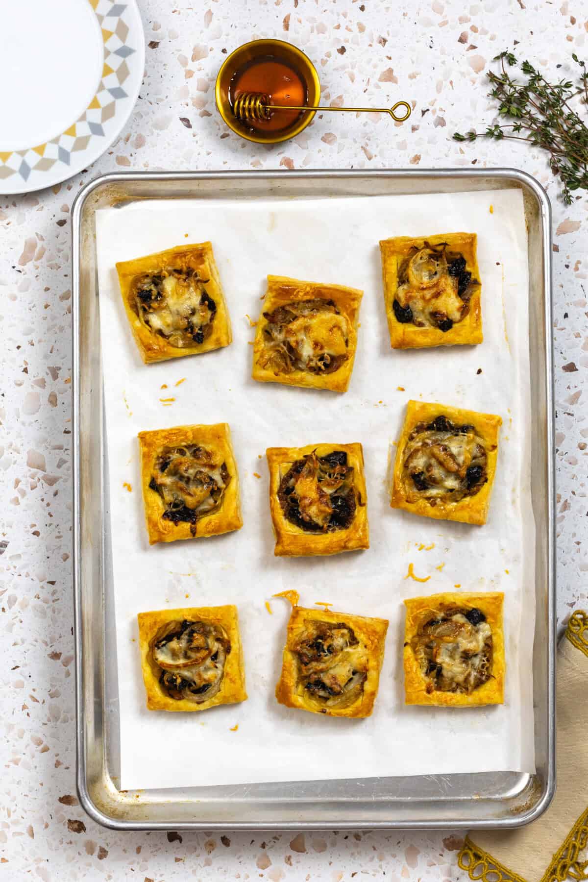 Baked Prune Onion Fontina Tarts after baking on a sheet pan