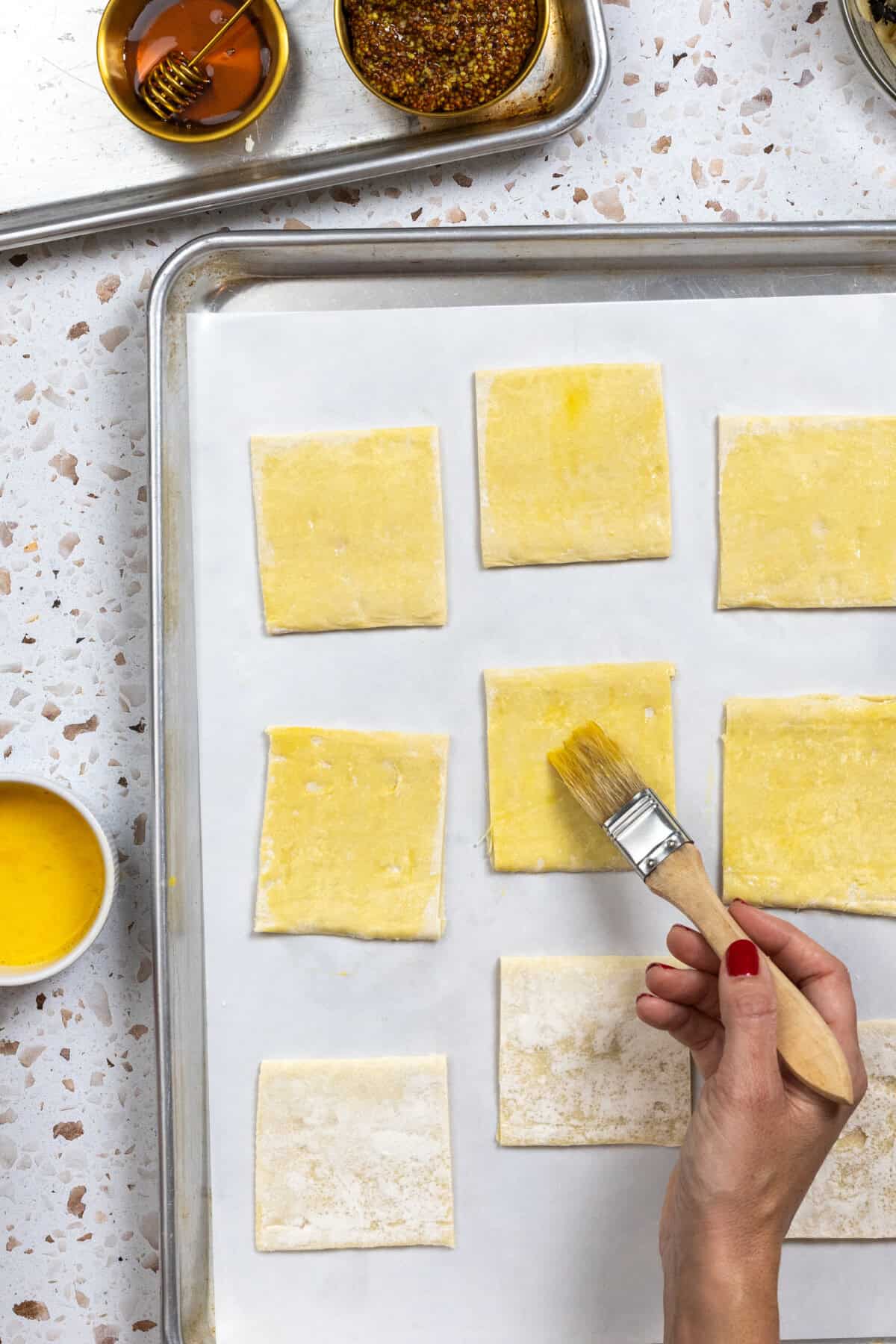 brushing puff pastry with egg wash