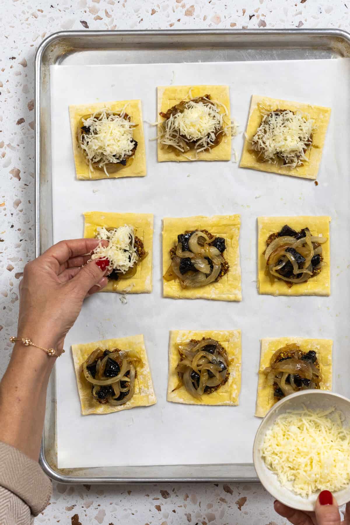 topping the prune onion tarts with Fontina cheese