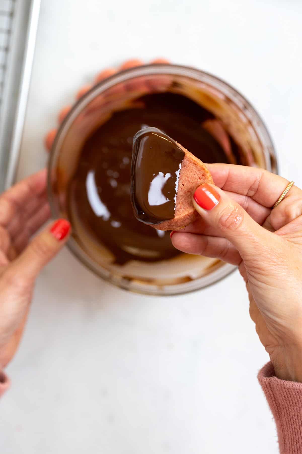 Dipping Strawberry Cookies in chocolate
