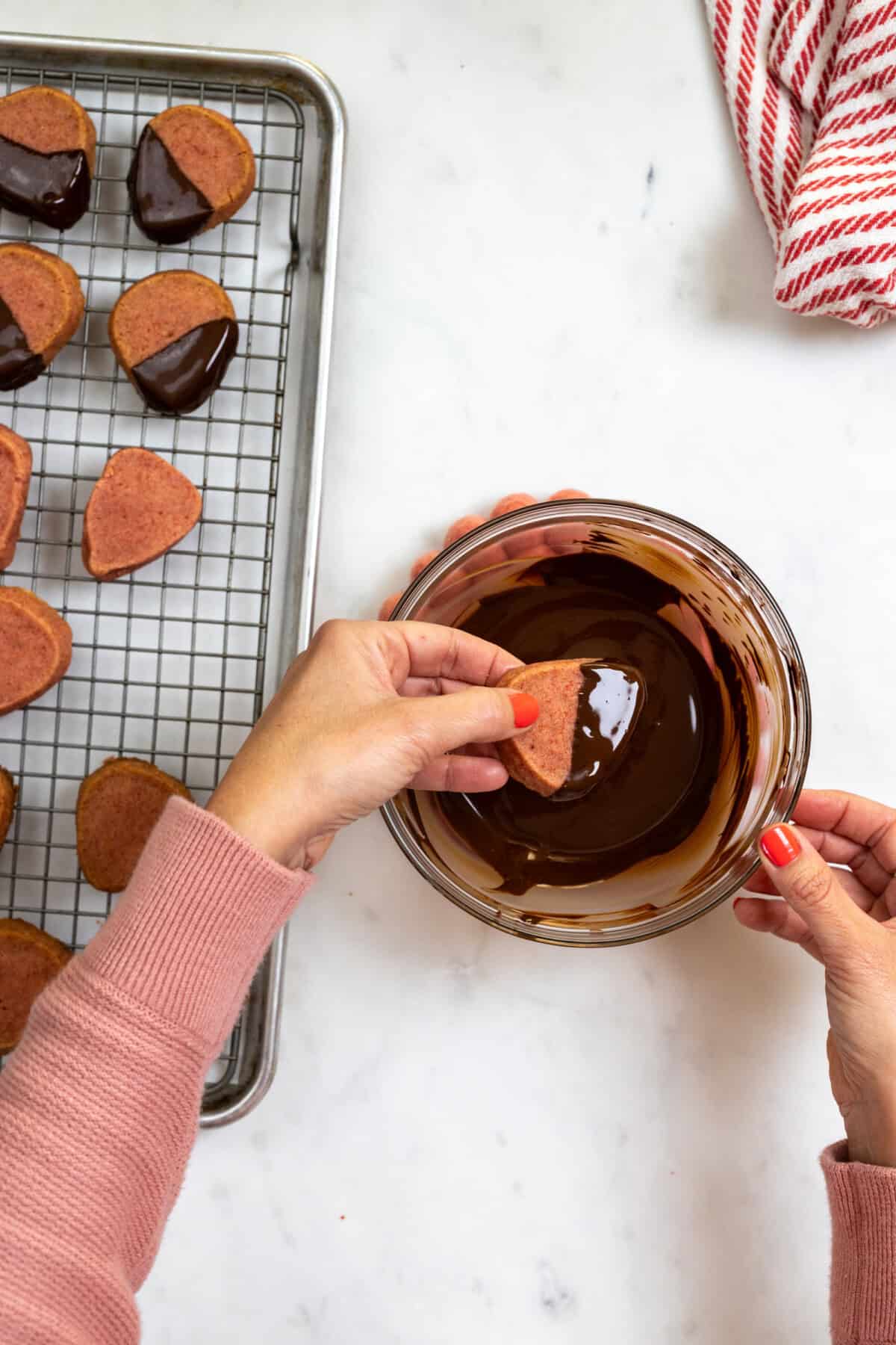 Dipping Strawberry Cookies in chocolate