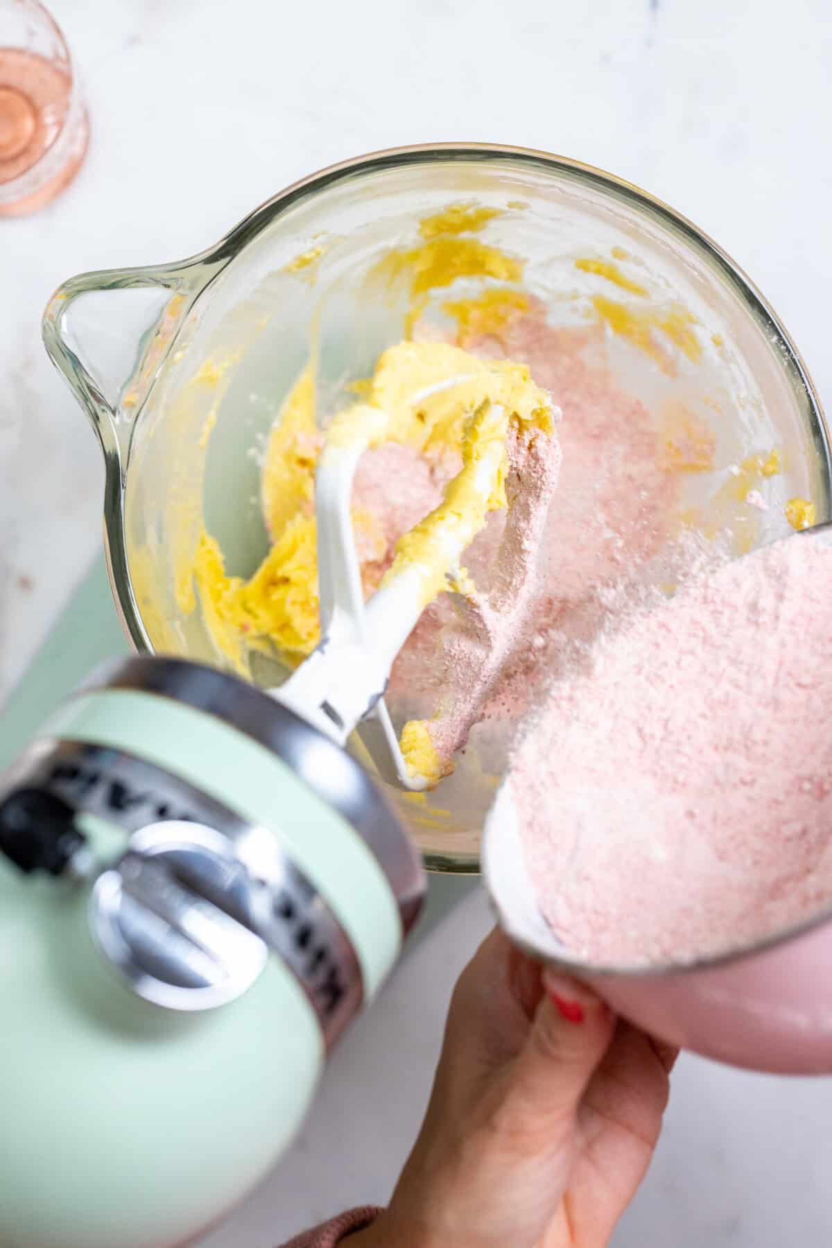 adding dry ingredients to strawberry cookie dough