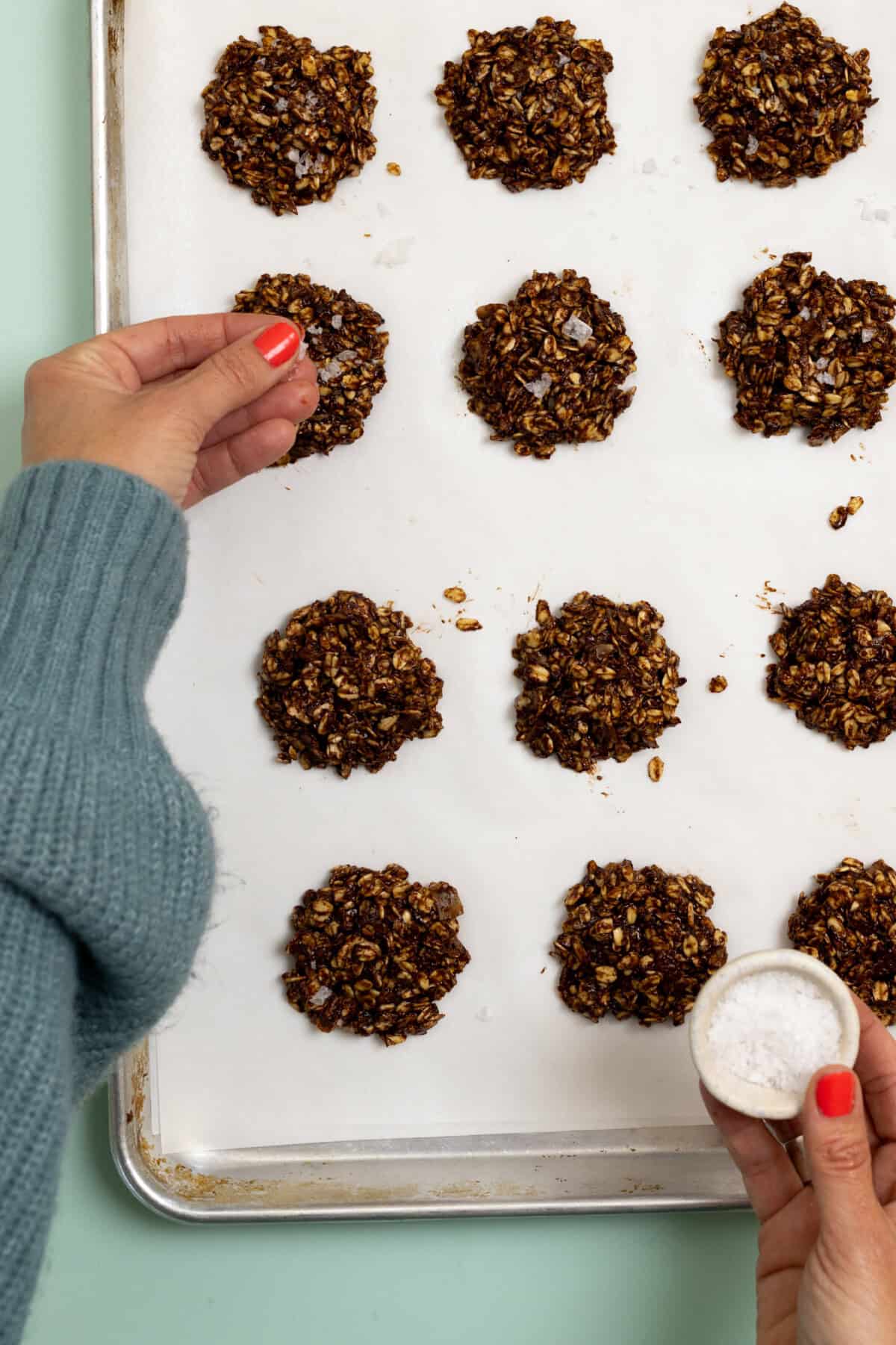 Sprinkling Scooping Healthier No Bake Cookies with sea salt flakes