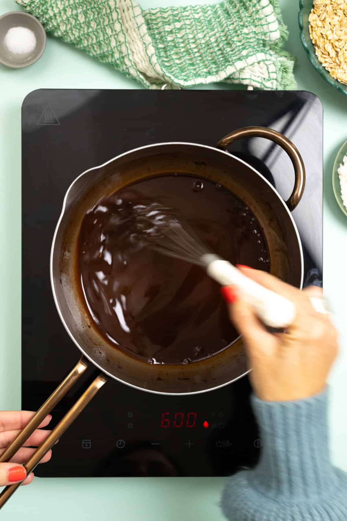 whisking chocolate sauce together