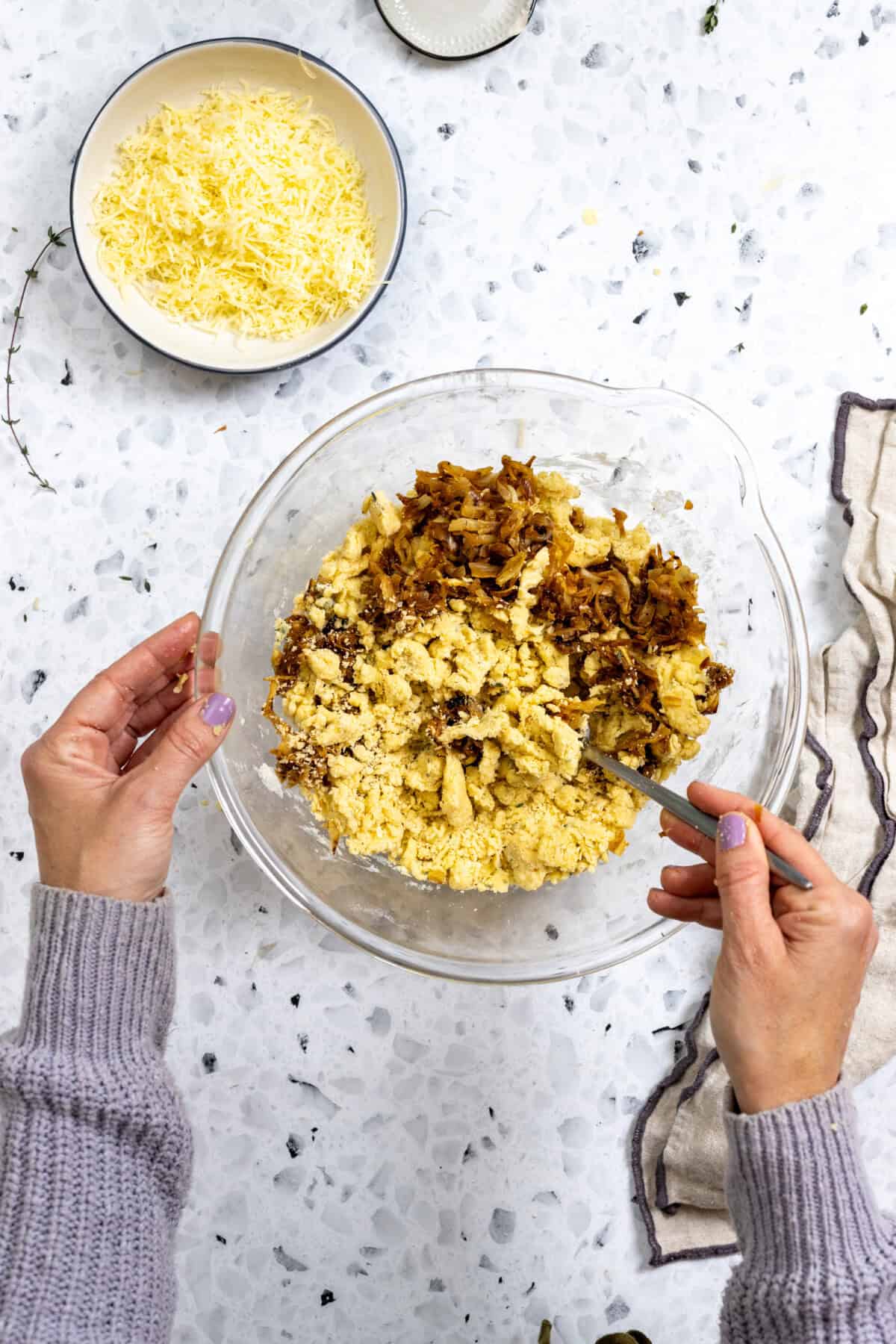 mixing caramelized onions into French Onion Scone dough