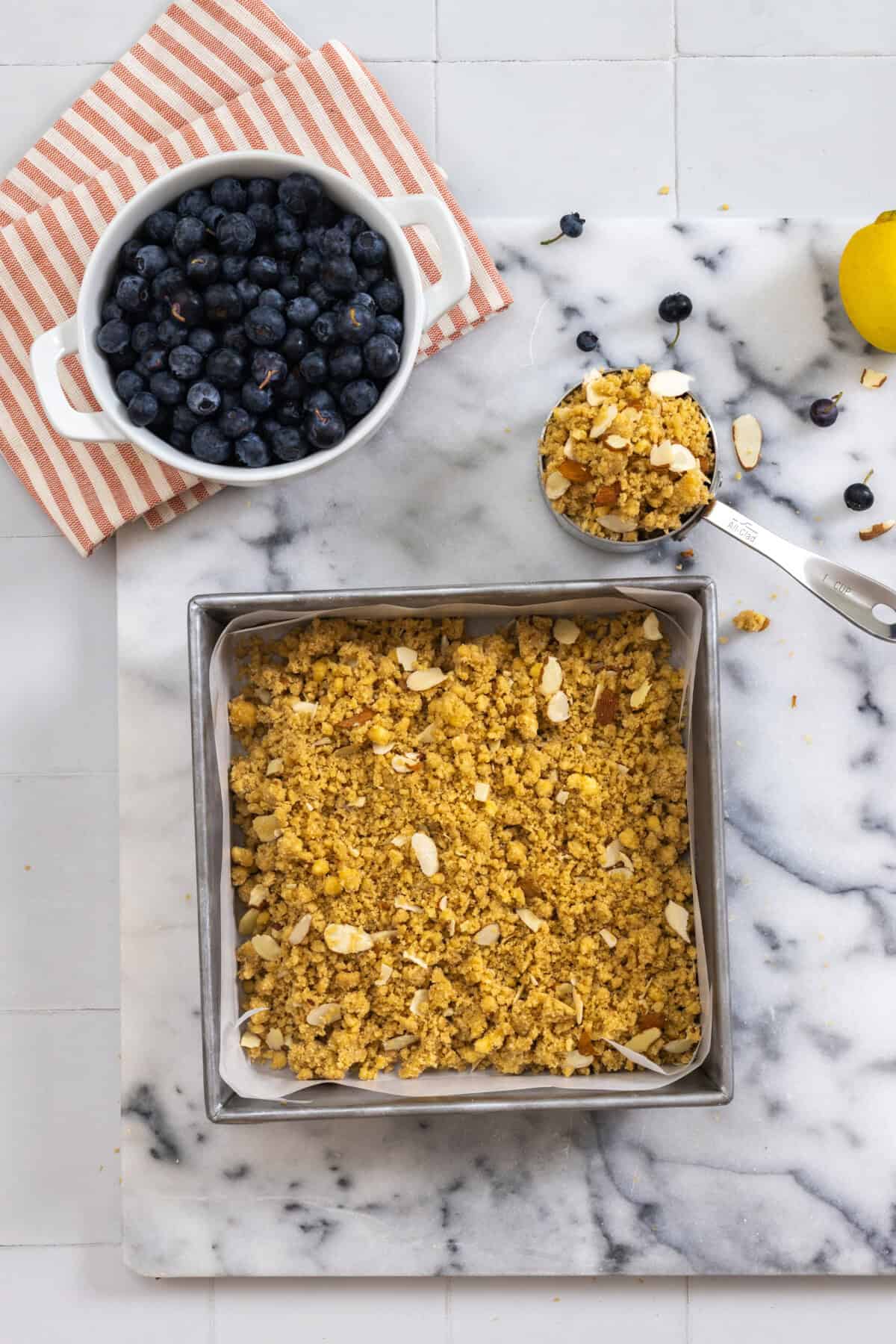 mixing almond crumble shortbread in pan