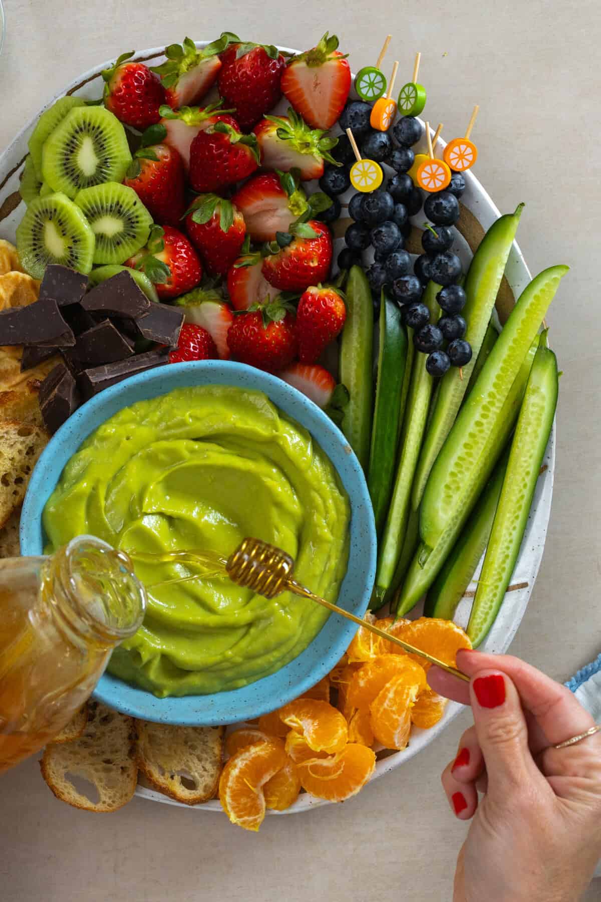 adding honey to Sweet Avocado Dip
