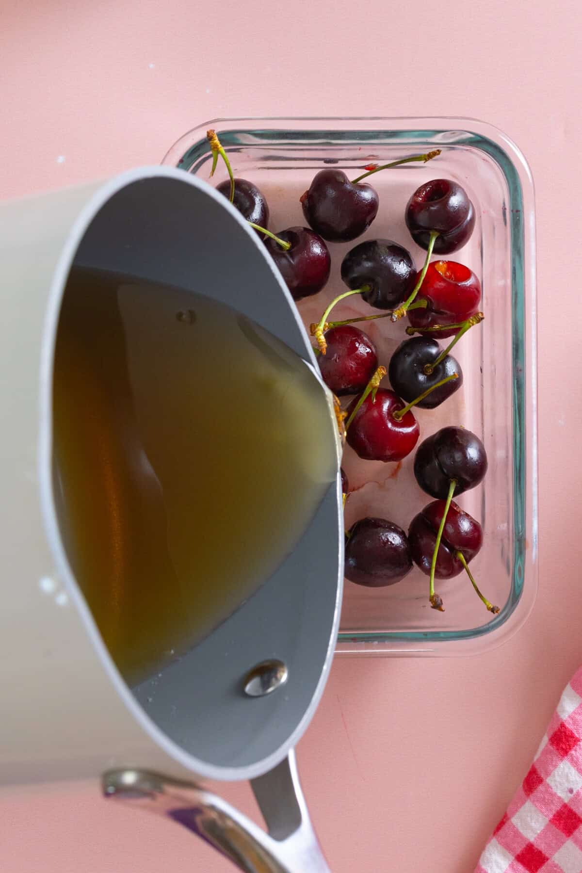 pouring brandy syrup over cherries