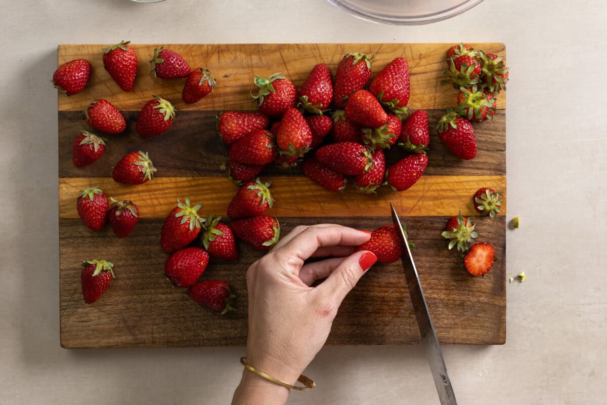 slicing strawberries for olive oil cake