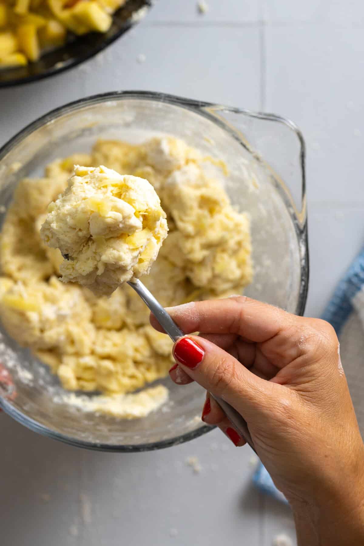 Scooping Cheddar Drop Biscuit dough