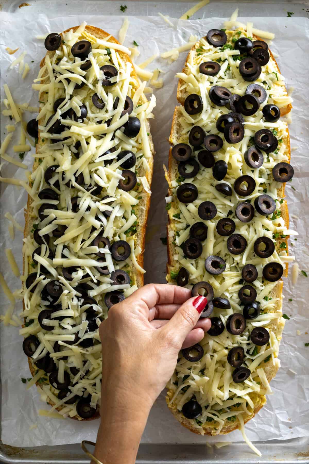 Topping garlic bread with olives