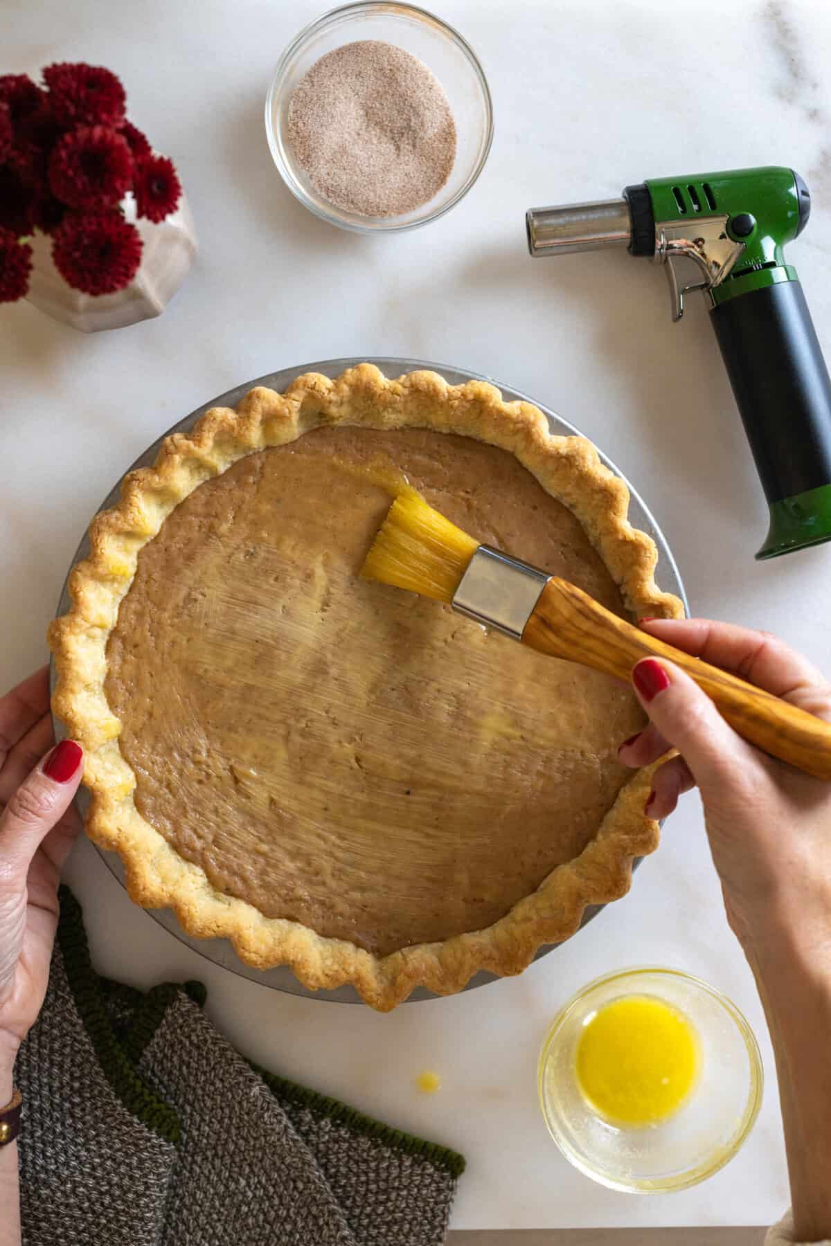 Buttering the top of the set pie