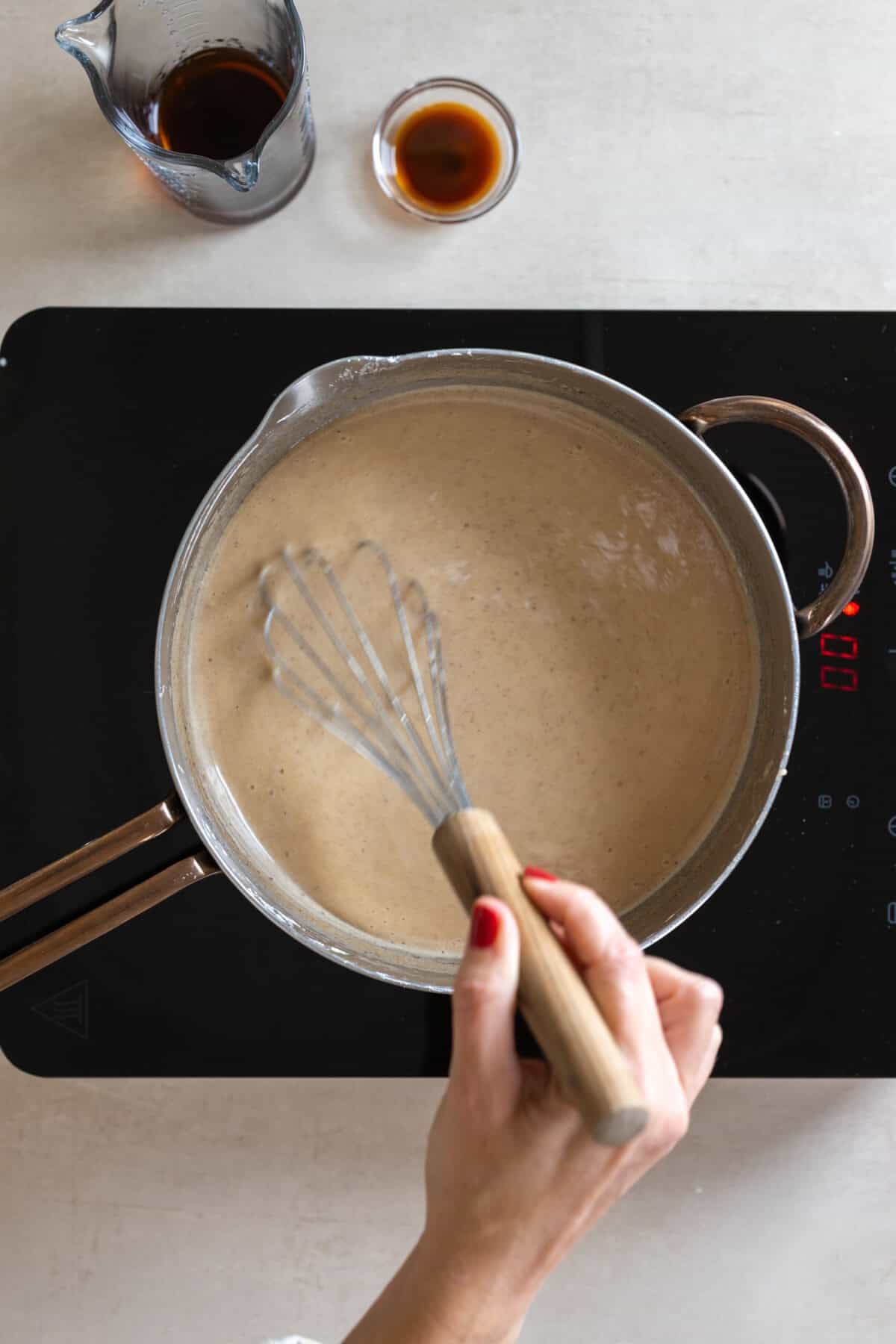 whisking Hot Adding butter to Rum Sugar Pie filling