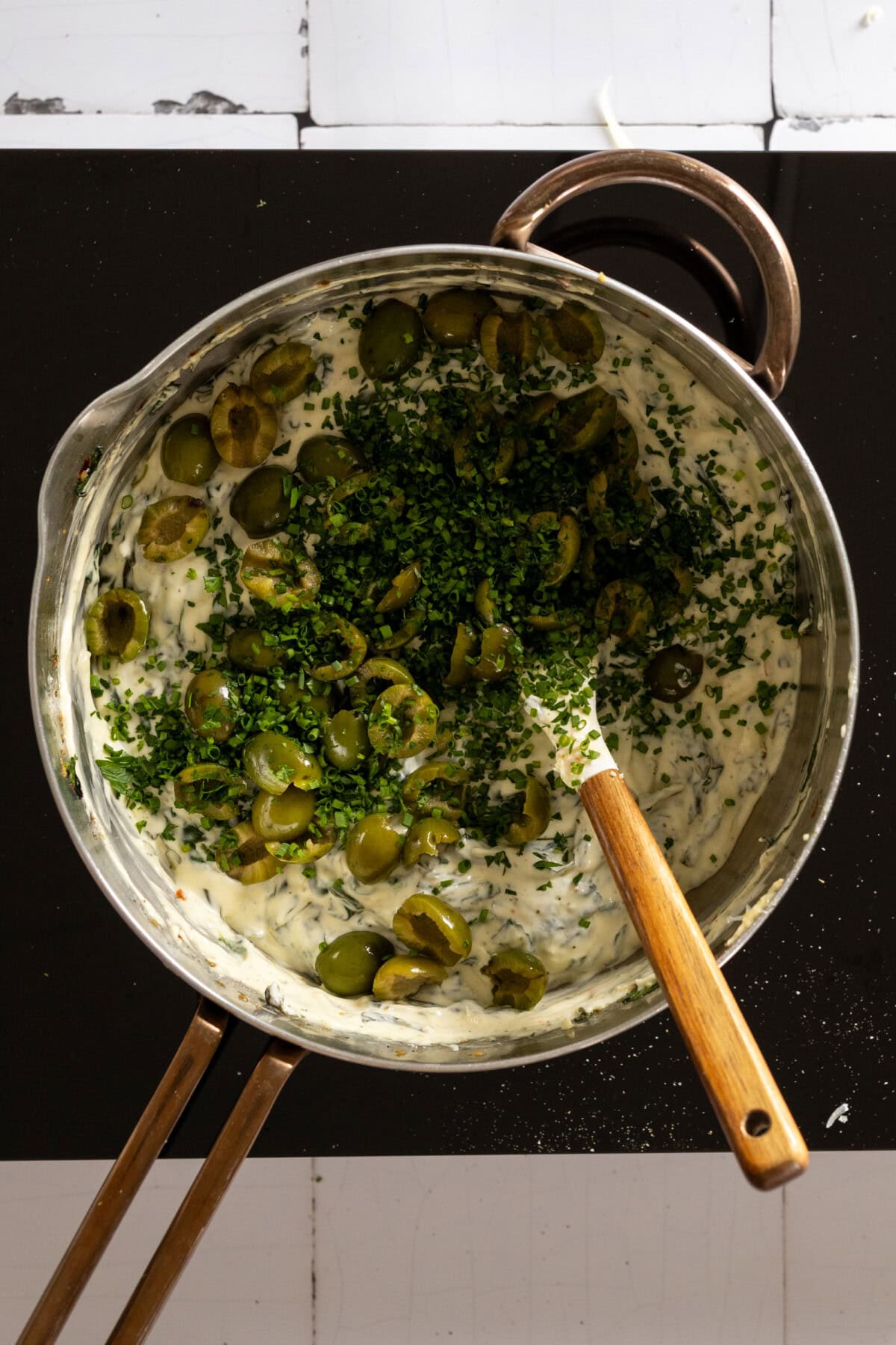 Adding olives and herbs to dip