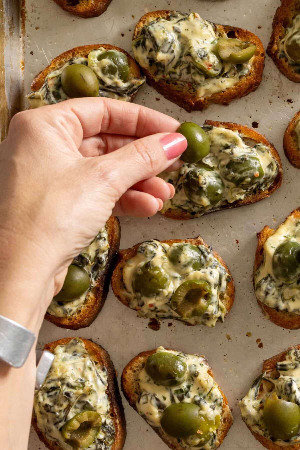 Topping Crostini with olives